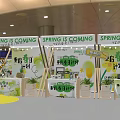 Exhibition Booths With White Canopies Green Yellow Decorations Plants And Circular Central Area