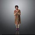 Woman Standing In Floral Dress With Clasped Hands And Purple Shoes On Gray Background