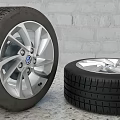 Stacked Car Tires And Tire With Volkswagen Wheel Rim On Brick Wall Background