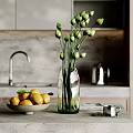 Decorative Accessories Set With Green Bud Vase Lemon Bowl And Silver Cup On Kitchen Countertop