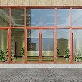 Entrance Glass Door with Red Frame Beige Wall Green Plants and Gray Brick Floor