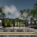 Evening Commercial Landscape With Lighted Mesh Structures Fountains Trees And Public Area