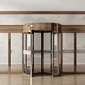 Modern Brass Frame Revolving Door With Glass Panels Surrounding Glass Doors And Wooden Floor