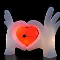 White Hand Shaped Art Installation With Illuminated Red Heart Center