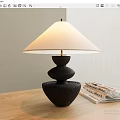 Modern Black Base Table Lamp With White Lampshade And Magazines On Wooden Table