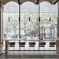 Modern Long Bar Counter With Green Chairs And Large Windows Overlooking Trees