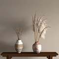 Decorative Ceramic Vases With Dried Pampas Grass On Wooden Table Against Beige Wall