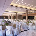 Elegant Banquet Hall Interior With Decorated Tables Chairs Floral Arrangements And Ceiling Lights