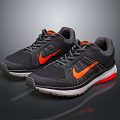 Black and Orange Athletic Running Shoes with Red Sole and Mesh Upper Design
