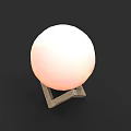 Modern Table Lamp With Spherical Soft Glow Shade And Triangular Base On Black Background