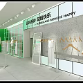 Modern Green Clothing Store Interior With Mannequins Racks And Green Plants