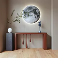 Brown Console Table with Green Branch and Blue Deer Statue Against Wall with Moon Decor