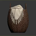 Brown Woven Basket With Two Handles Holding Beige Blanket On Gray Background