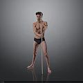 Shirtless Man in Black Underwear Standing with Long Pole Against Gray Background on Black Floor