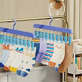 Colorful Patterned Socks Hanging On Blue Hangers With Clothespins Near Bookshelf