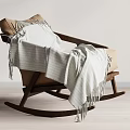 Cozy Brown Rocking Chair with Wooden Frame and White Striped Fringe Blanket