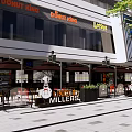 Modern Commercial Street Outdoor Area With Storefronts Umbrellas Plants And Pedestrians