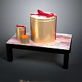 Golden Storage Buckets With Red Bows And Small Container On Black Table For Daily Use