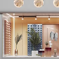 Fashionable Shop Window Display With Mannequins Decorative Spheres Green Plants And Warm Lighting