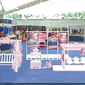 Pink Themed Tea Break Area With Cherry Blossom Backdrop White Bench Cart And Blue Carpet