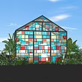 Colorful Stained Glass House Surrounded by Lush Plants Under Clear Blue Sky