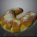 Freshly Baked C Shaped Sweet Bread With Golden Brown Crust And Powdered Sugar