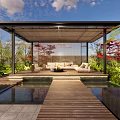Tranquil Courtyard Garden Featuring Covered Pavilion Wooden Walkway Water Pond and Lush Greenery Seating