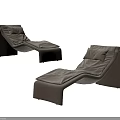 Two Modern Brown Leather Lounge Chairs With Ergonomic Backrest And Cushioned Seats