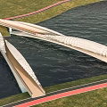 Modern Bridge Structure Over Water With Green Grass And Red Track