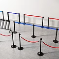 Various Metal Safety Barriers With Blue Red Railings Black Bases and Red Ropes