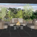 Outdoor Sofa Set With Fire Pit Coffee Table And Green Plants On Patio