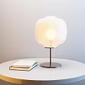 Illuminated White Cloud Table Lamp With Black Base On White Round Table With Two Books 3d model