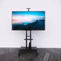 Flat screen Television on Black Stand Against White Wall with Wooden Floor Displaying Waterfront Sunset
