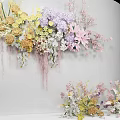 Elegant Floral Display With Wall Mounted And Floor Arrangements Featuring Pastel Yellow Purple Pink Flowers