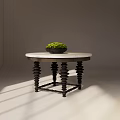 Round Dining Table With Marble Top Black Spiral Legs And Green Plant Bowl