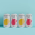 Four Tea Latte Cans With Yellow Pink Design On Light Blue Background