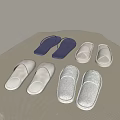 Multiple pairs of soft indoor slippers in white light gray and blue on woven mat