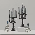 Tabletop Metal Candelabra With Black And White Striped Candles And Small Figurines