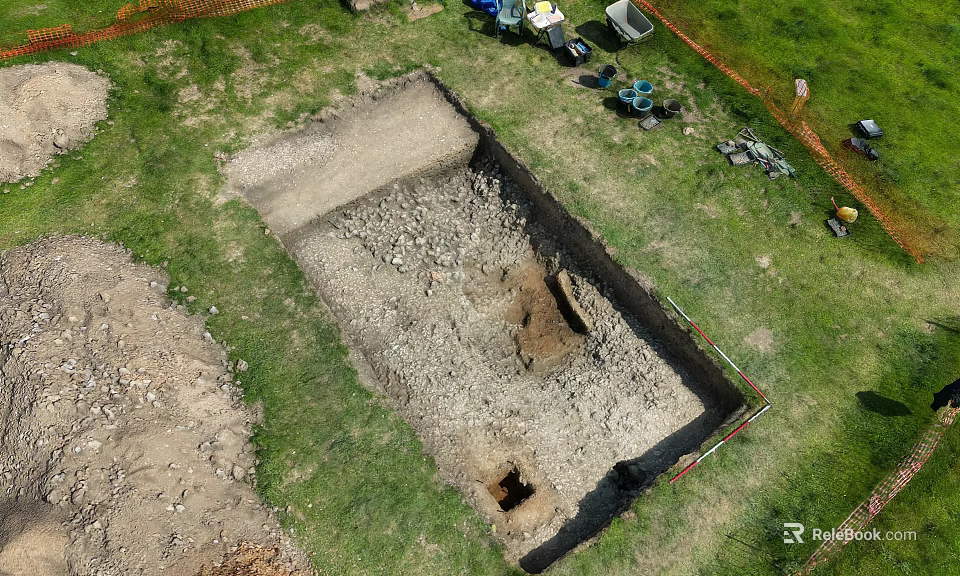 Top Down Aerial View Of Outdoor Archaeological Excavation Trench On Grassy Site With Working Tools 3d model 