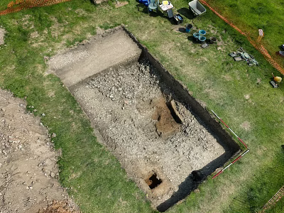 Top Down Aerial View Of Outdoor Archaeological Excavation Trench On Grassy Site With Working Tools 3d model