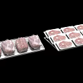 Fresh Raw Meat Pieces Packaged in White Trays for Display and Sale