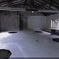 Unfinished Building Interior With Wooden Beams Damaged Walls Windows And Circular Floor Depressions