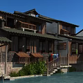 Traditional Chinese Ancient Architecture With Wooden Structure Tile Roof Stone Stairs And Plants By Water