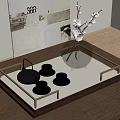 Elegant Tea Set with Black Teapot Golden Cups on Decorative Tray with Glass Vase