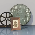 Gray Swing Door With Vintage Clock Wheel Decor And Photo Frame On Table