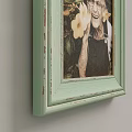Light Green And Light Blue Photo Frames With Photos Hanging On Wall