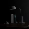 White Curved Arm Table Lamp Illuminating Reading Books with Coffee Cup on Wooden Round Table