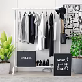 White Clothes Rack With Hanging Clothes CHANEL Sign Shoes New Arrivals Board And Decorative Plants