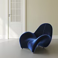 Blue Velvet Accent Chair With Modern Curved Design In Bright Light Room