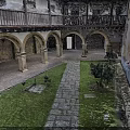 Historic Building Courtyard With Arched Arcades Stone Columns Flagstone Path Lawn And Green Plants